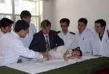 Beijing/China, 21-29 May 2005 - Screening at a Kindergarten, checking for movement of the right hip, looking for a causative factor in the etiology of so called idiopathic scoliosis 